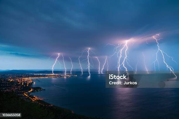 Sea City Lightning Storm Stock Photo - Download Image Now - Lightning, Thunderstorm, Sea