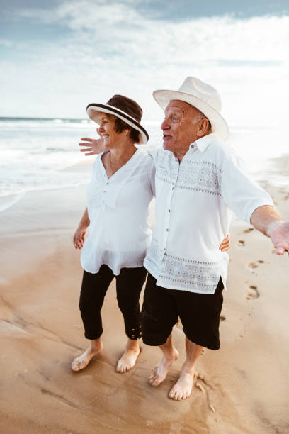 istock happiness senior couple walking togetherness on the beach 1036655670