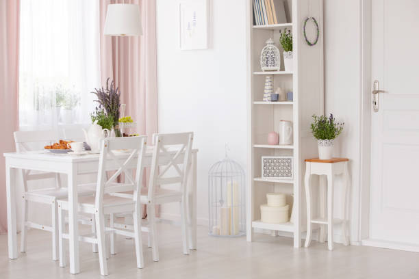 istock White chairs and table with flowers under lamp in dining room interior with lavender flowers. Real photo 1036660806