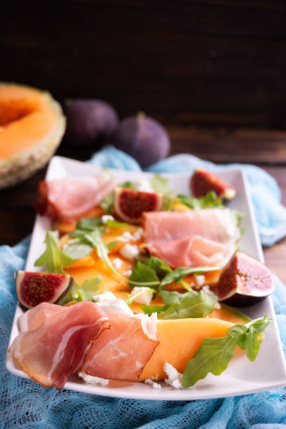 istock Close up of plate with melon, arugula and prosciutto 1036661740