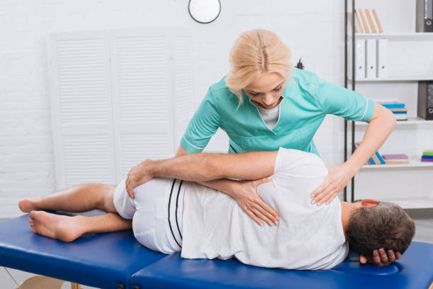 istock chiropractor massaging back on patient on massage table in hospital 1036666630