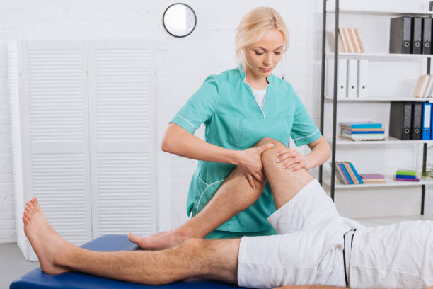 istock partial view of chiropractor massaging patients leg during appointment in clinic 1036666682