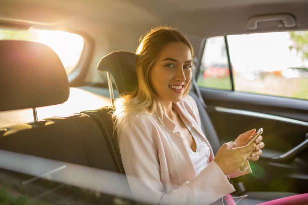 istock Woman with smart phone in a car 1036683116