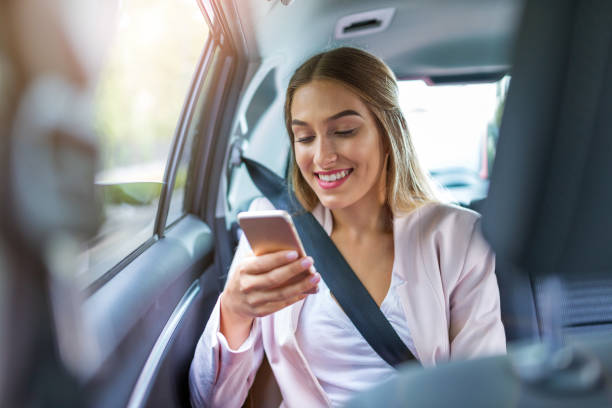 istock Woman with smart phone in a car 1036683554