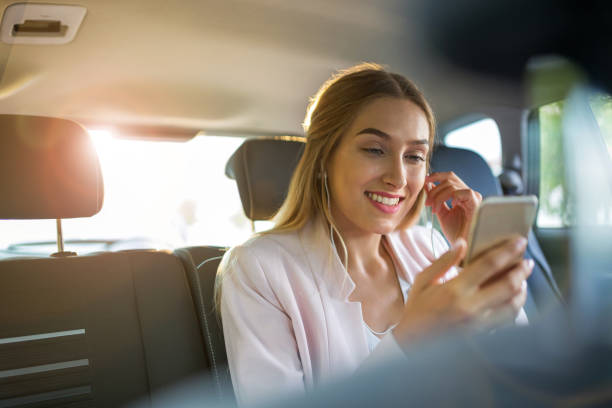 istock Woman with smart phone in a car 1036683738