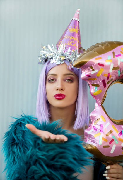 istock Woman with balloon and party hat 1036683874