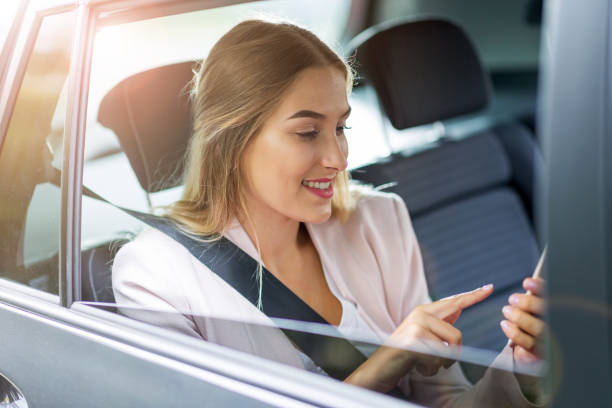 istock Woman with smart phone in a car 1036684500