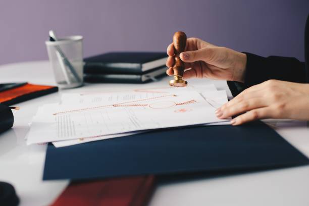 istock Woman notary public stamping document 1036688910
