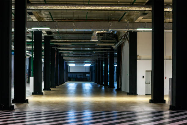 istock Empty storage room corridor. Prospect of receding columns. Tall black columns. 1036702142
