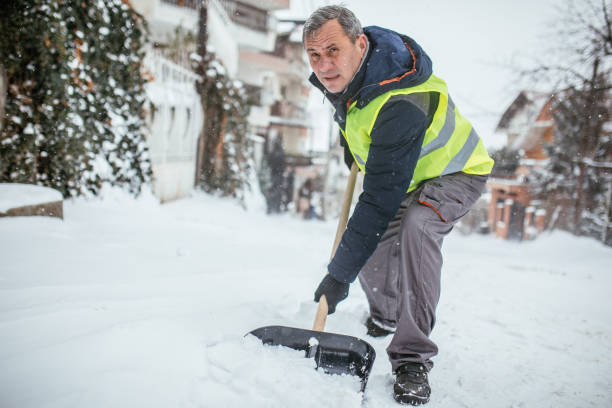 istock Senior man cleaning snowy doorway 1036708534