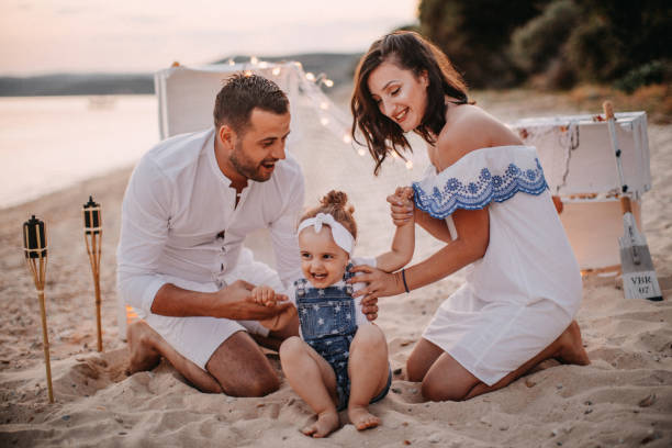 istock Happy family on sunset beach 1036713098