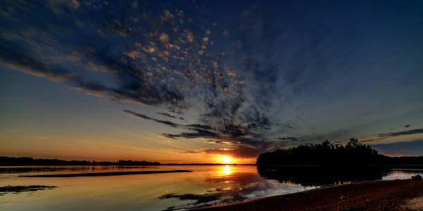istock Beautiful orange sunset with reflection in the river 1036713504