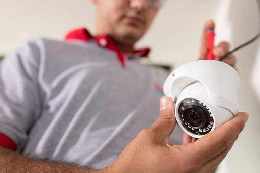 Technician Installing Security Camera