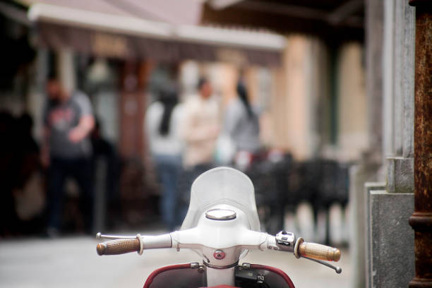 istock Handlebar of old scooter stationary on sidewalk. 1036714556