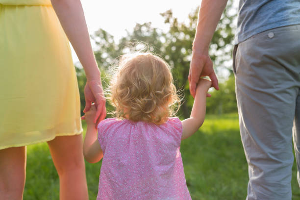istock Family walking in park 1036718364