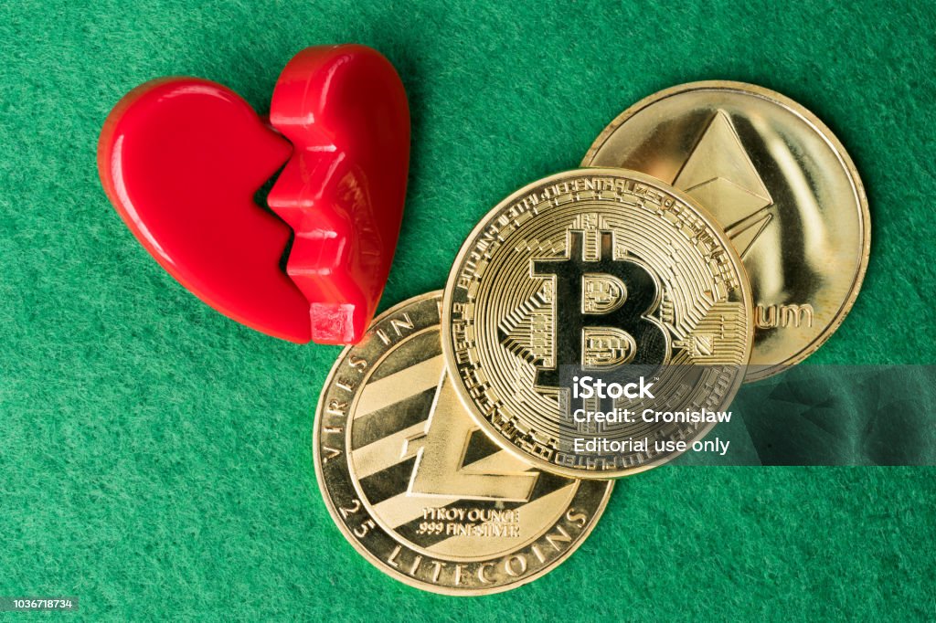 Gold physical Bitcoin, Litecoin and Ethereum coins with broken heart. Gdansk, Poland - 5 September 2018: Gold physical Bitcoin, Litecoin and Ethereum coins with broken heart on green background. Crypto currency market break or no love abstract concept. Flat lay top view. Casino Stock Photo