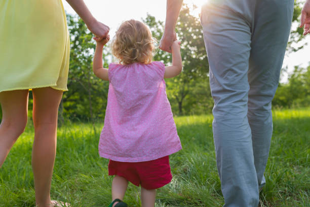 istock Family walking in park 1036724418