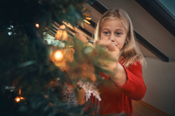 istock Decorating Christmas Tree with Ornaments and Christmas Lights 1036728800