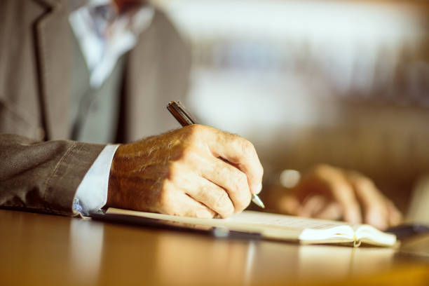 istock Senior businessman writing his agenda 1036729774