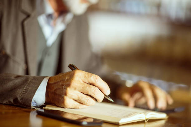 istock Senior businessman writing his agenda 1036730080