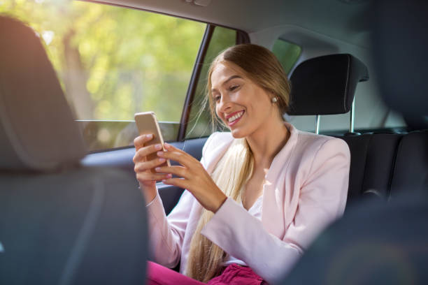istock Woman with smart phone in a car 1036732136