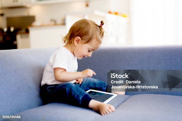 Cute Girl Using Digital Tablet Stock Photo - Download Image Now - Digital Tablet, Toddler, Child