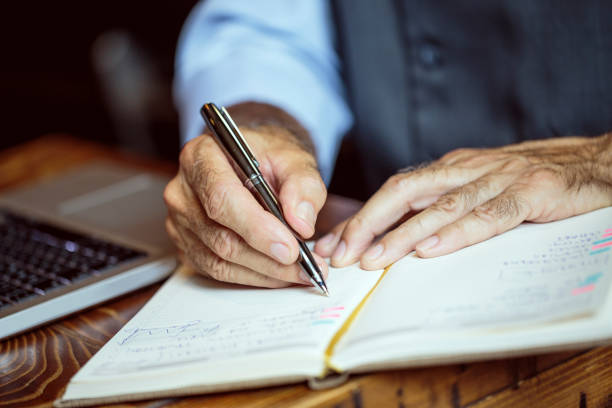 istock Businessman writing his agenda 1036734948
