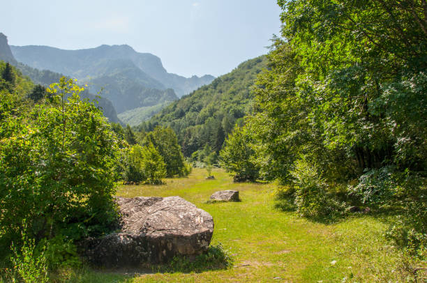 A glade among the mountains with large stones on it