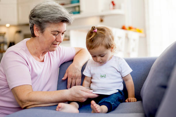 istock grandmother teaching her granddaughter with digital tablet 1036736748