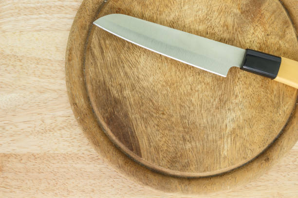istock kitchen knife on cutting board on wooden table. 1036741006