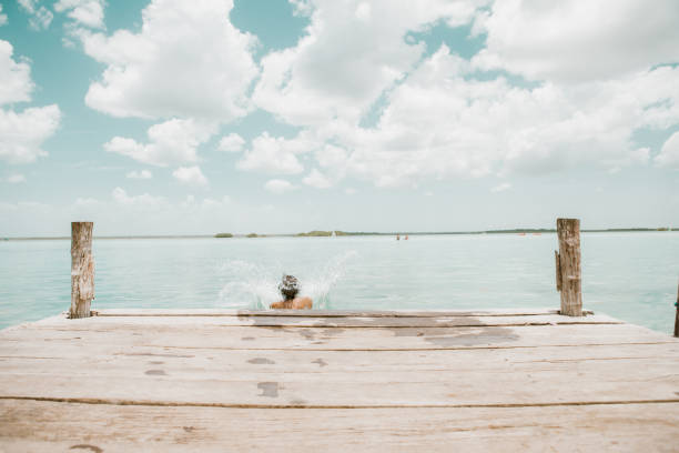 istock Woman jumping from pier 1036742692