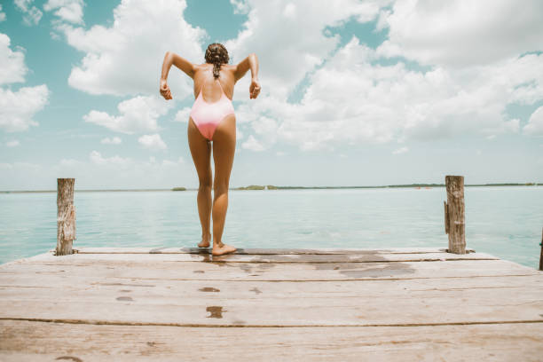 the sport or activity of propelling oneself through water using the limbs