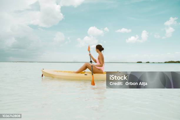 Woman Using Kayak In Bacalar Stock Photo - Download Image Now - Mayan Riviera, Bahamas, Beach