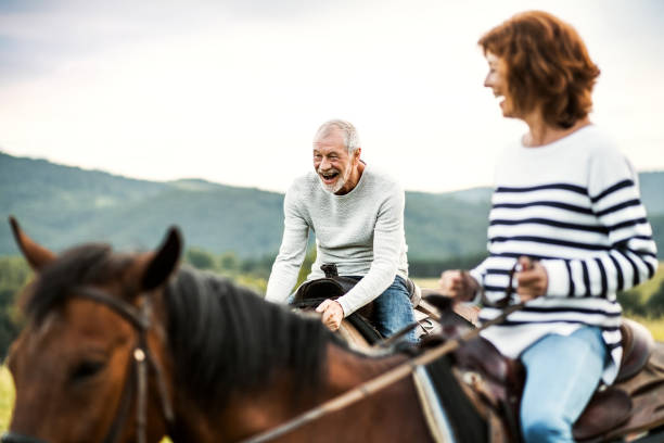 istock A senior couple riding horses in nature. 1036746254
