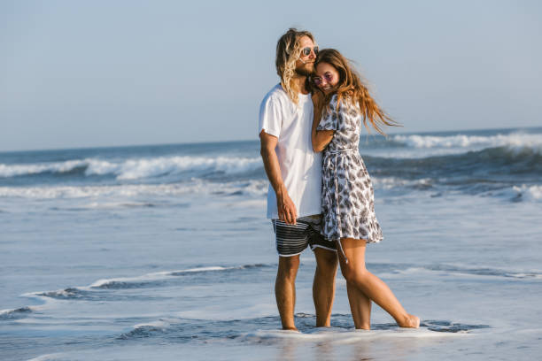 istock couple cuddling on ocean beach in bali, indonesia 1036748238