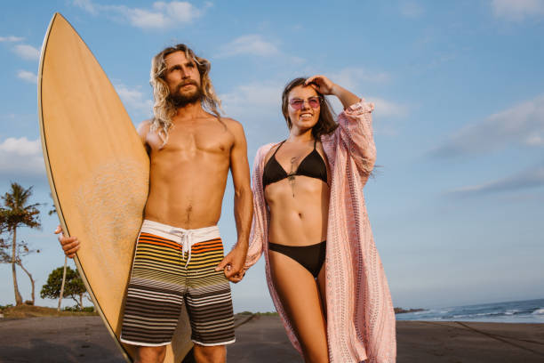 istock couple holding hands on beach in bali, indonesia 1036748534