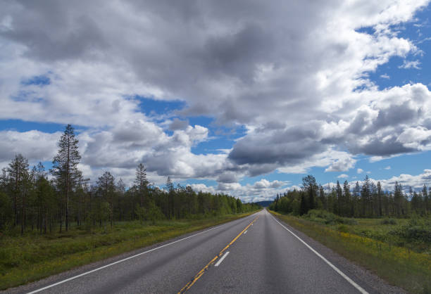 istock Warm summer day in northern Finland with empty road 1036751976