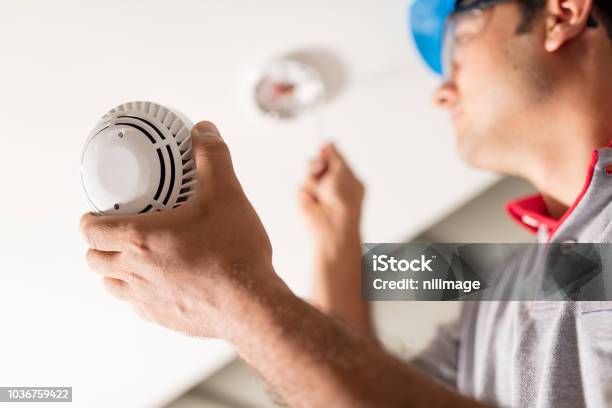 Man Installing Smoke Detector Stock Photo - Download Image Now - Fire - Natural Phenomenon, Smoke Detector, Safety
