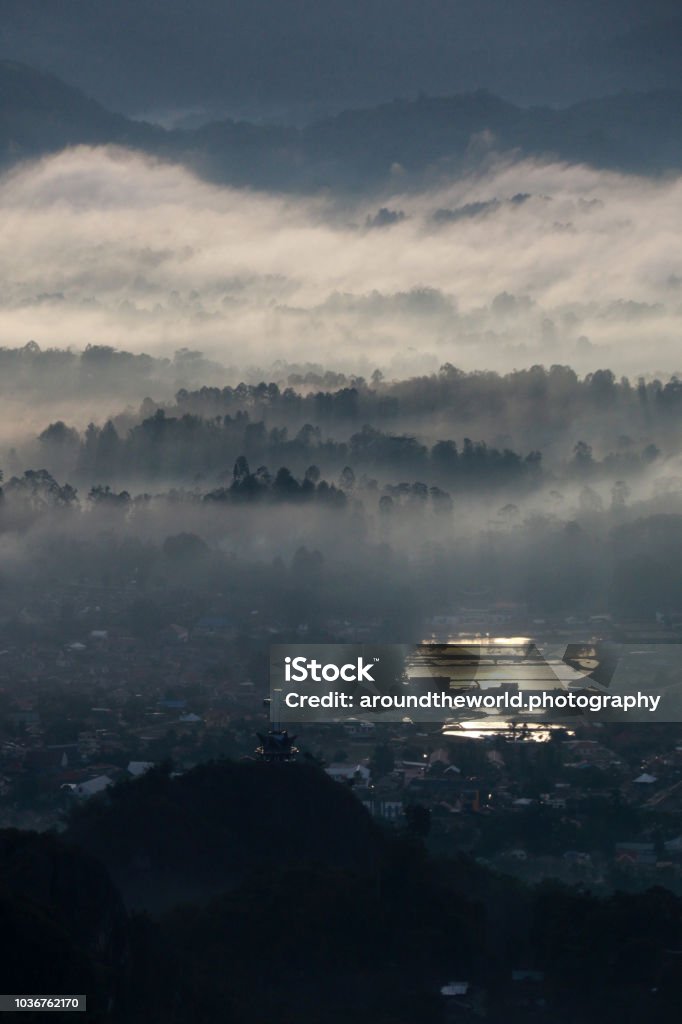 Low Level Clouds and Fog overhead Toraja Utara in Toraja, Sulawesi, Indonesia View from To'Tombi, Toraja, Sulawesi, Indonesia Blue Stock Photo