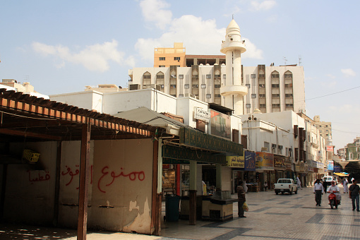 Jeddah, Saudi Arabia - October 25th, 2009: Pedestrian Zone near the historic Al-Balad district. A minaret of a mosque is rising in the background. Plenty of people strolling across the.