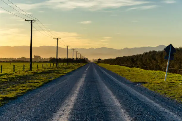 Sunset draws closer on a road running towards the Southern Alps, on New Zealand's South Island.