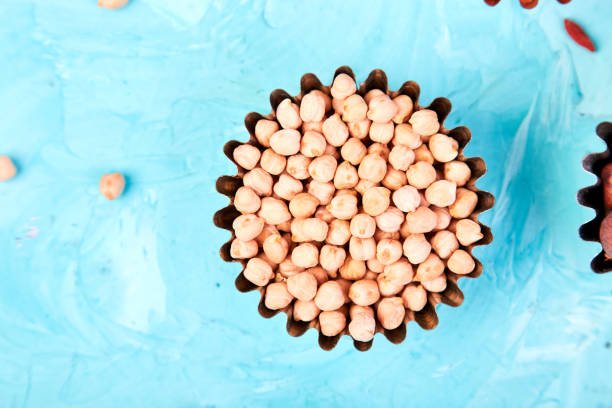 superfoods chickpea in small bowl on blue background. - quinoa sesame chia flax seed imagens e fotografias de stock