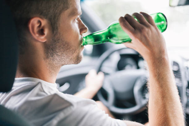 istock Drunk driver behind the steering wheel of a car 1036767562