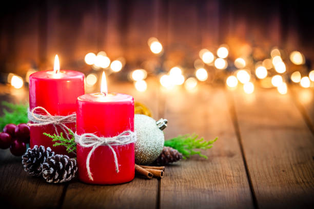 istock Christmas candles on rustic wooden table 1036767936