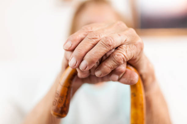 istock Elderly woman with a walking stick 1036768788