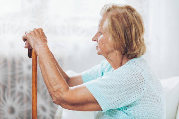 istock Elderly woman with a walking stick 1036773128