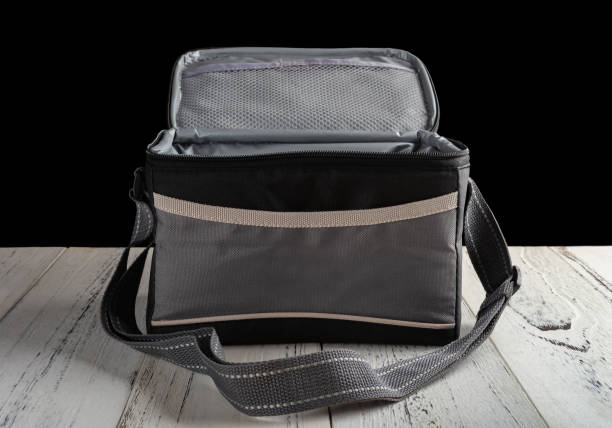 istock front view grey and black lunch pack carrier on a wood table on black background with the top open 1036773802