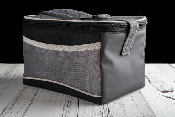 istock side view grey and black lunch pack carrier on a wood table on black background 1036773846