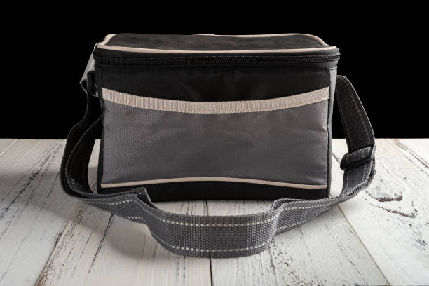 istock front view grey and black lunch pack carrier on a wood table on black background 1036774004