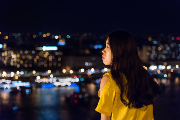 istock Girl enjoying night city view from above 1036780310